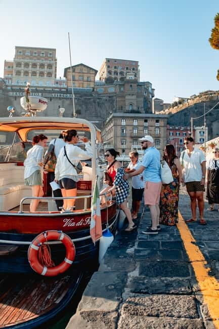 Capri and Blue Grotto Day Tour From Sorrento with 8 People - Sailing Capri’s signature sights: Faraglioni and Punta Carena